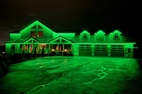 House illuminated with green roofline lights from X Series Classic
